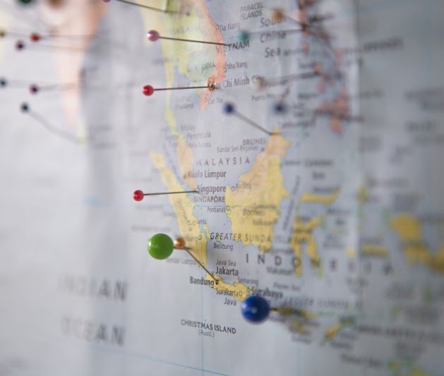 Pins in a map of the world indicating travel