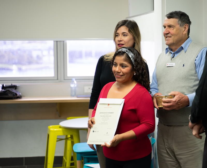Student receiving Certificate of Attainment after completing a corporate training course.